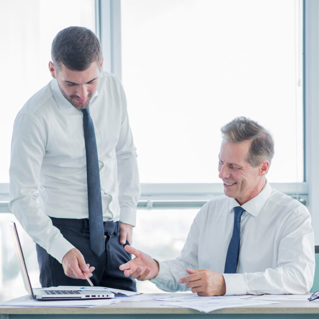 RCM consultant reviewing a client portfolio with a colleague