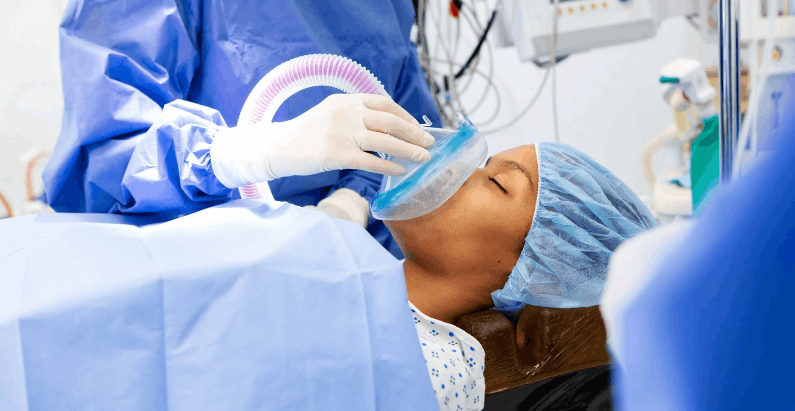 Anesthesia provider managing a patient airway in an operating room