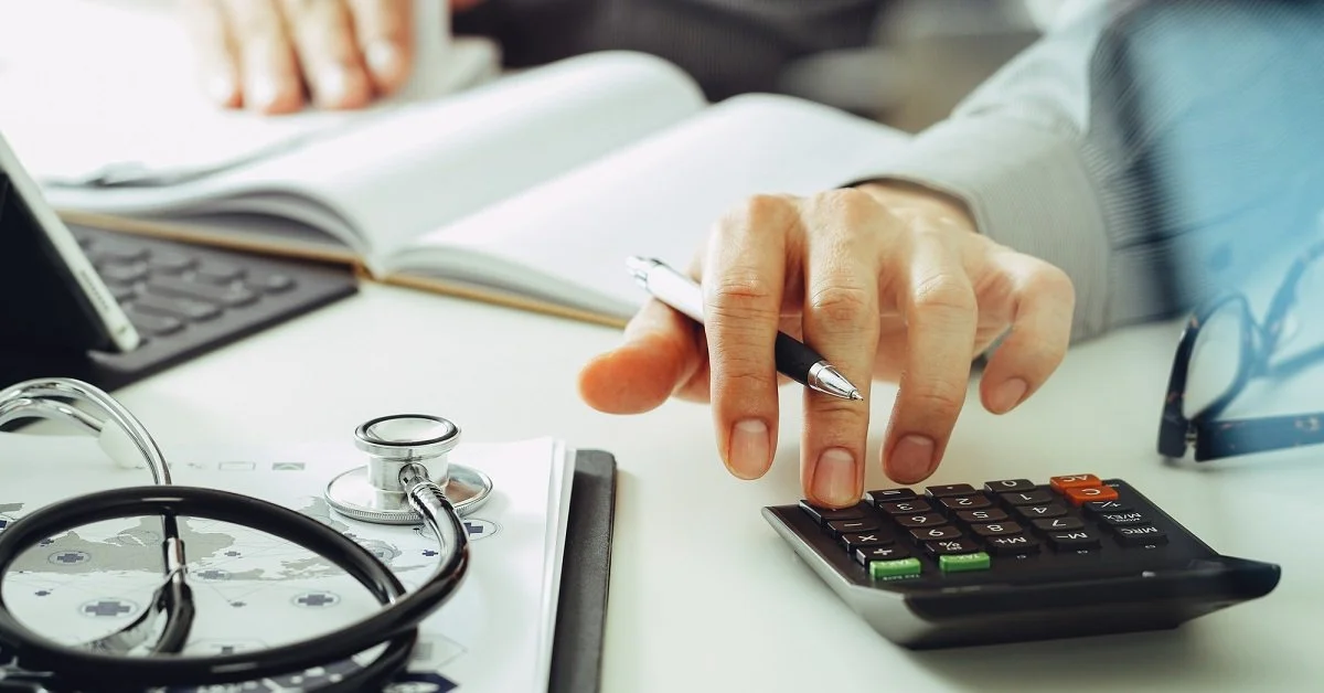 Calculator and stethoscope on a durable medical equipment billing desk