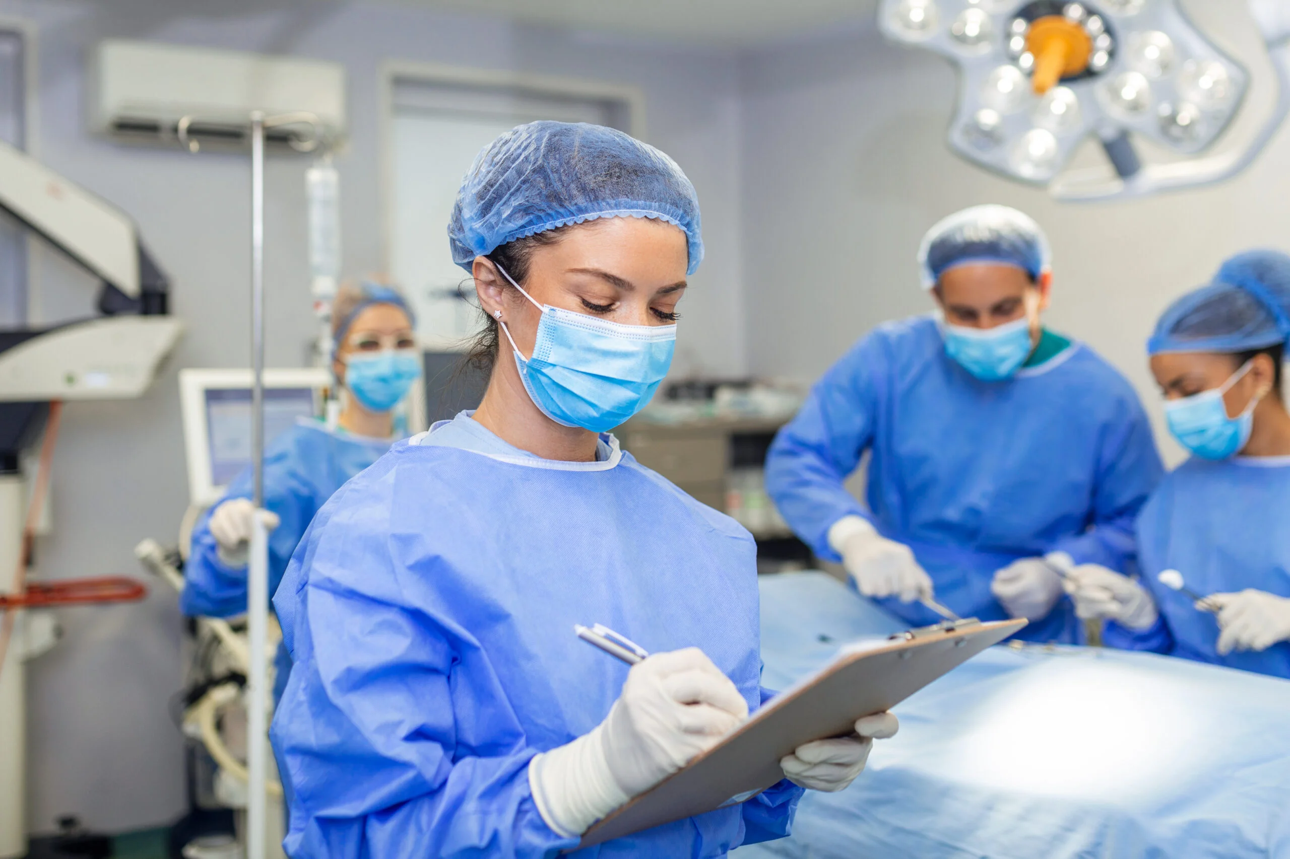 Clinician completing patient paperwork on a clipboard