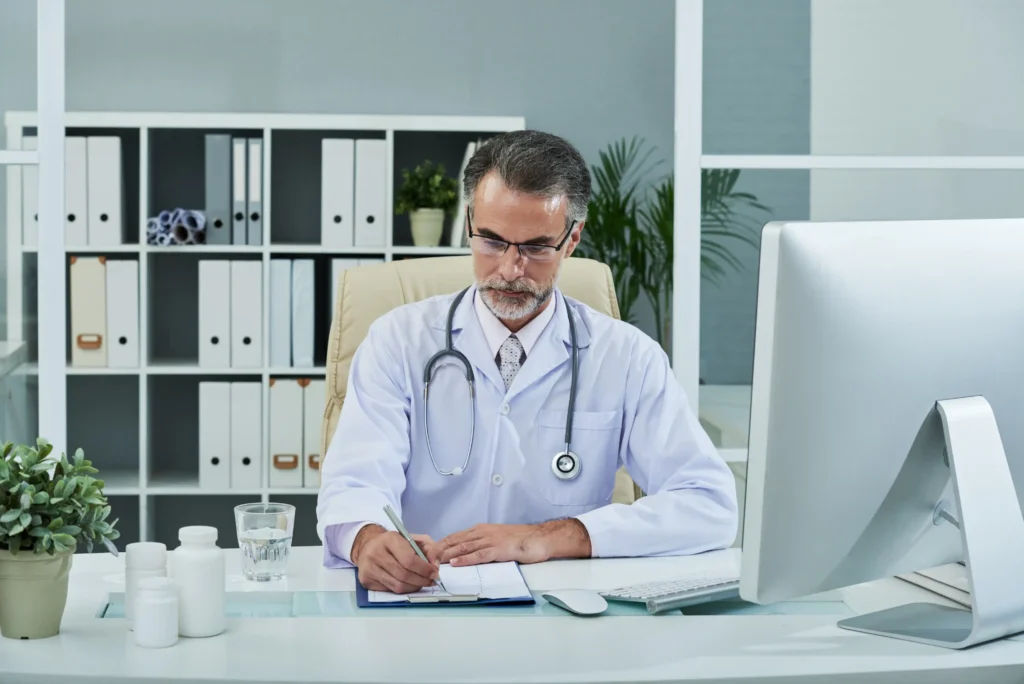 Rehabilitation physician reviewing plan of care documentation