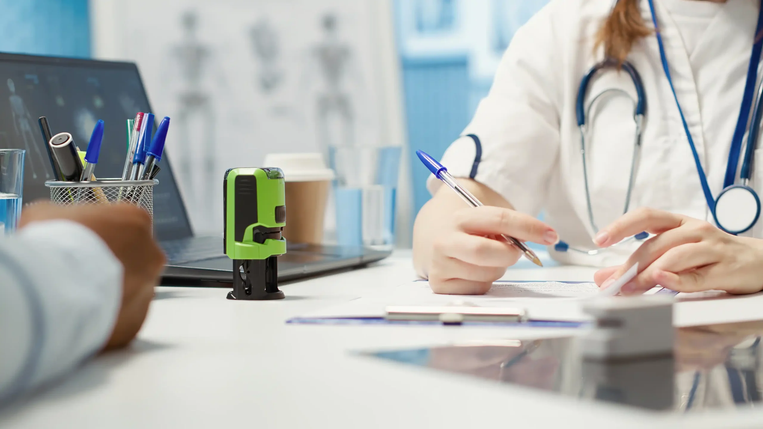 Rehabilitation clinician documenting a therapy session beside treatment equipment