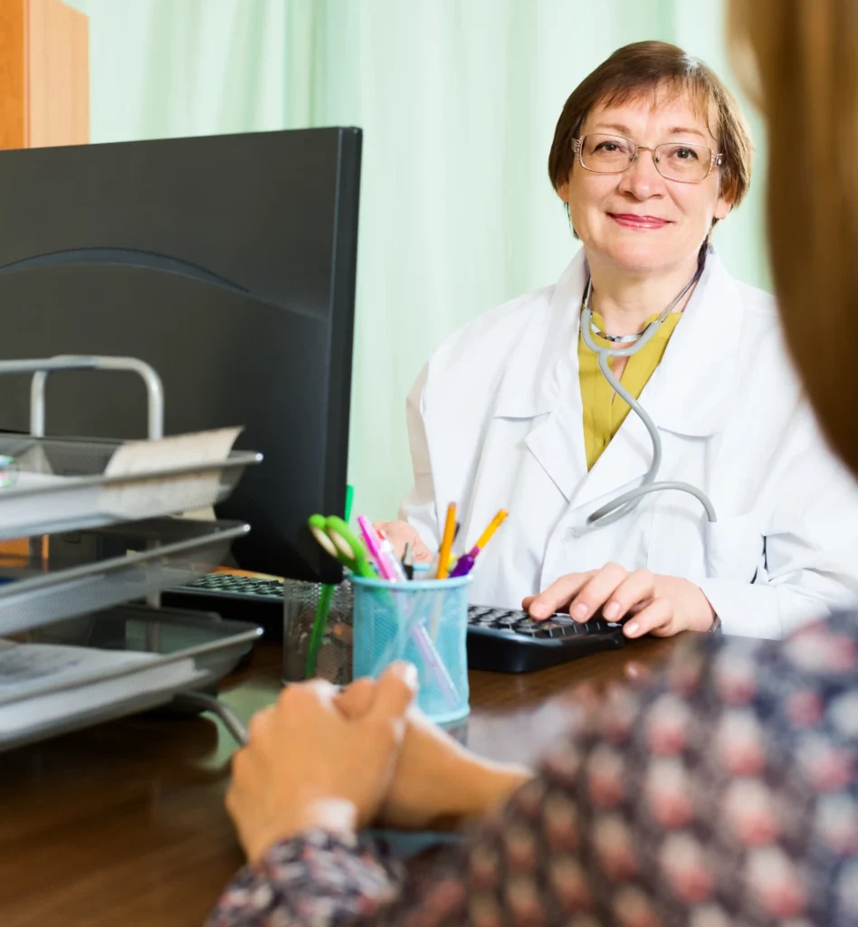 Speech therapy clinician reviewing evaluation notes at a desk