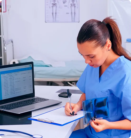 Nurse completing billing paperwork at a clinic workstation