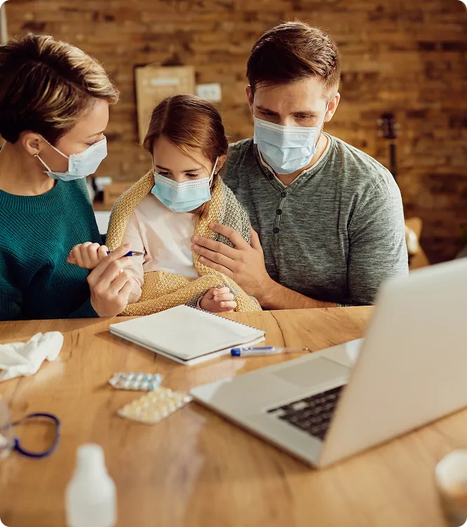 Family reviewing medication and coverage paperwork together during a family medicine visit