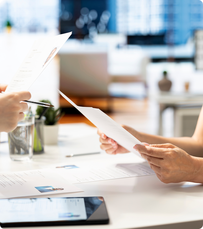 Urgent care staff handing over patient registration documents