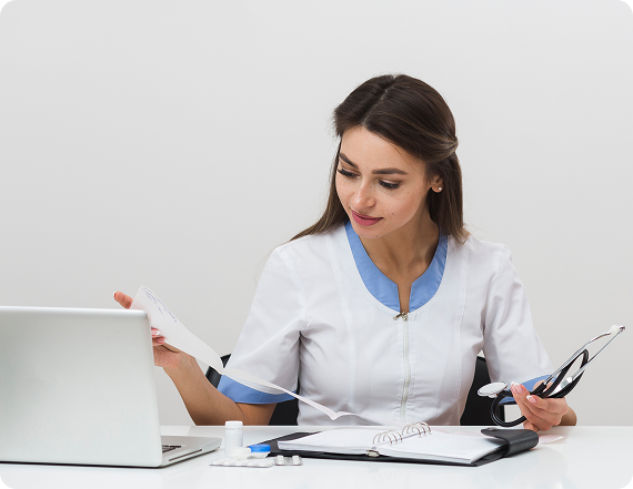 Urgent care clinician reviewing patient paperwork at a workstation