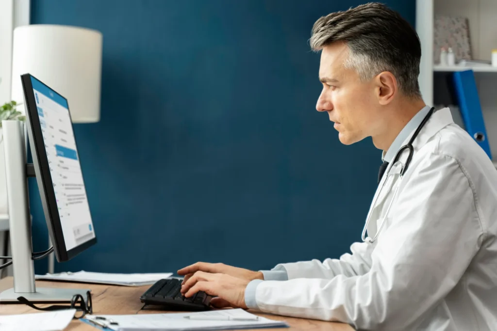 Physician working through a patient chart on screen during a telehealth session