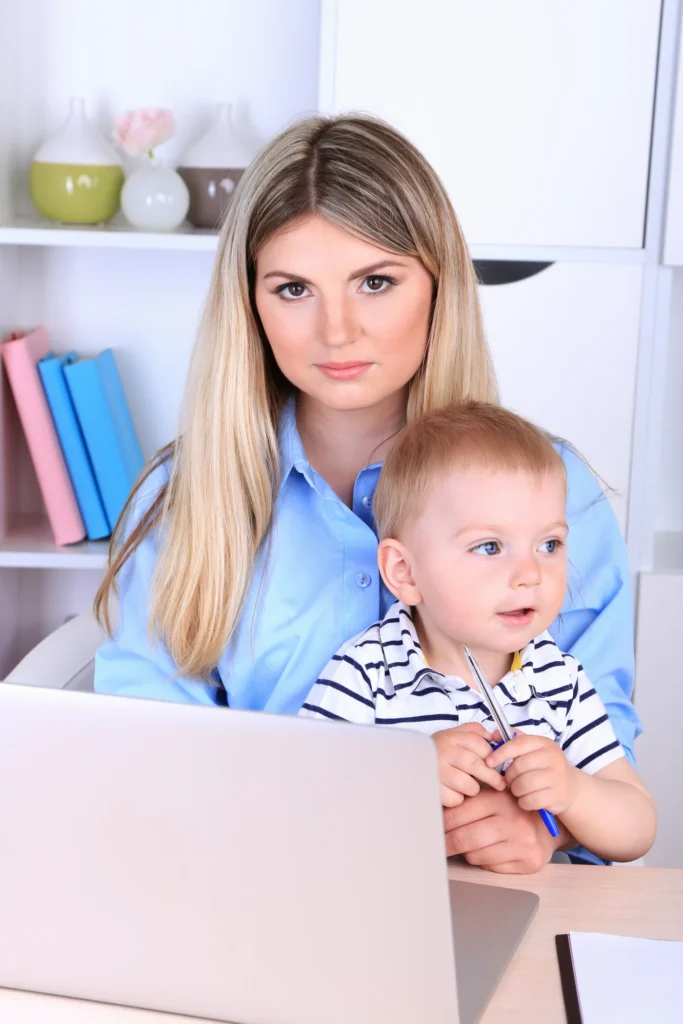 Parent and infant at a laptop during an eligibility check