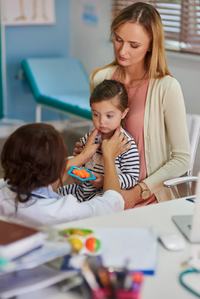 Parent with two children in a pediatric waiting room