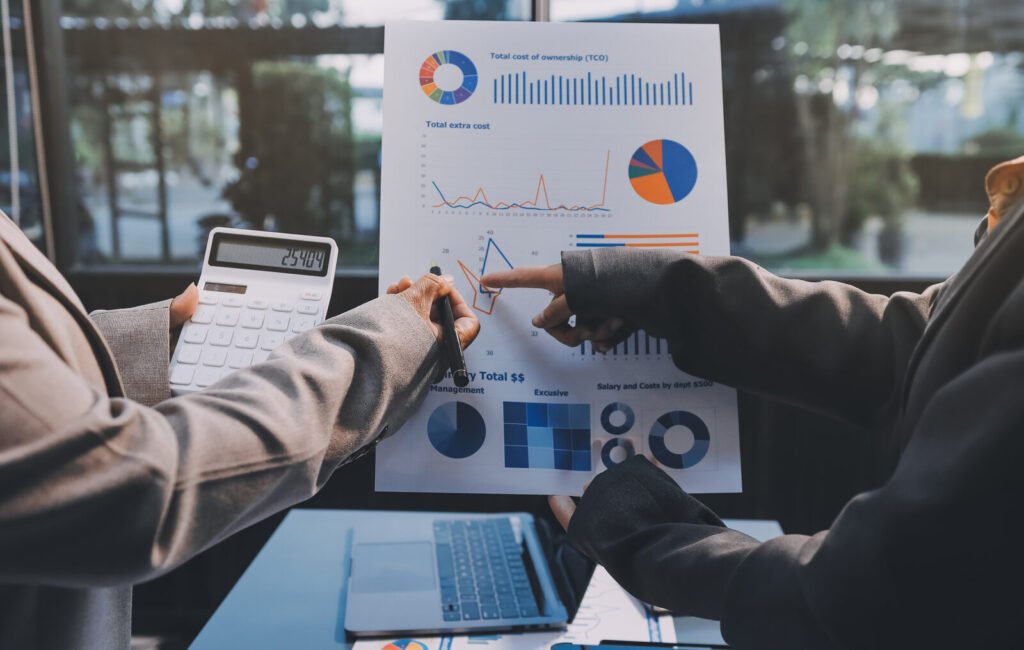 A team reviewing printed performance charts across a meeting table