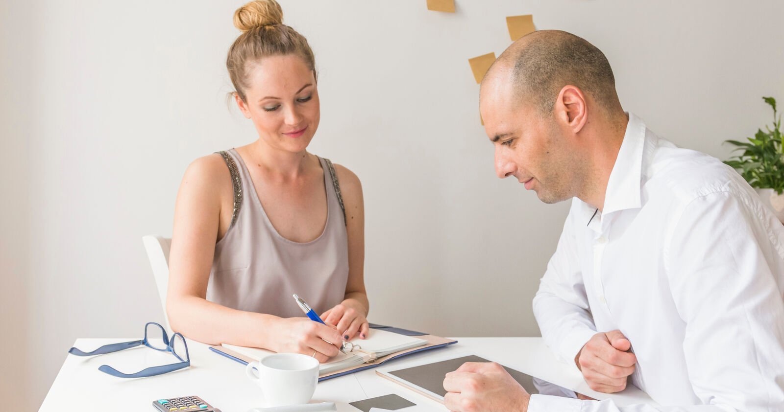 A practitioner and a patient talking across a desk